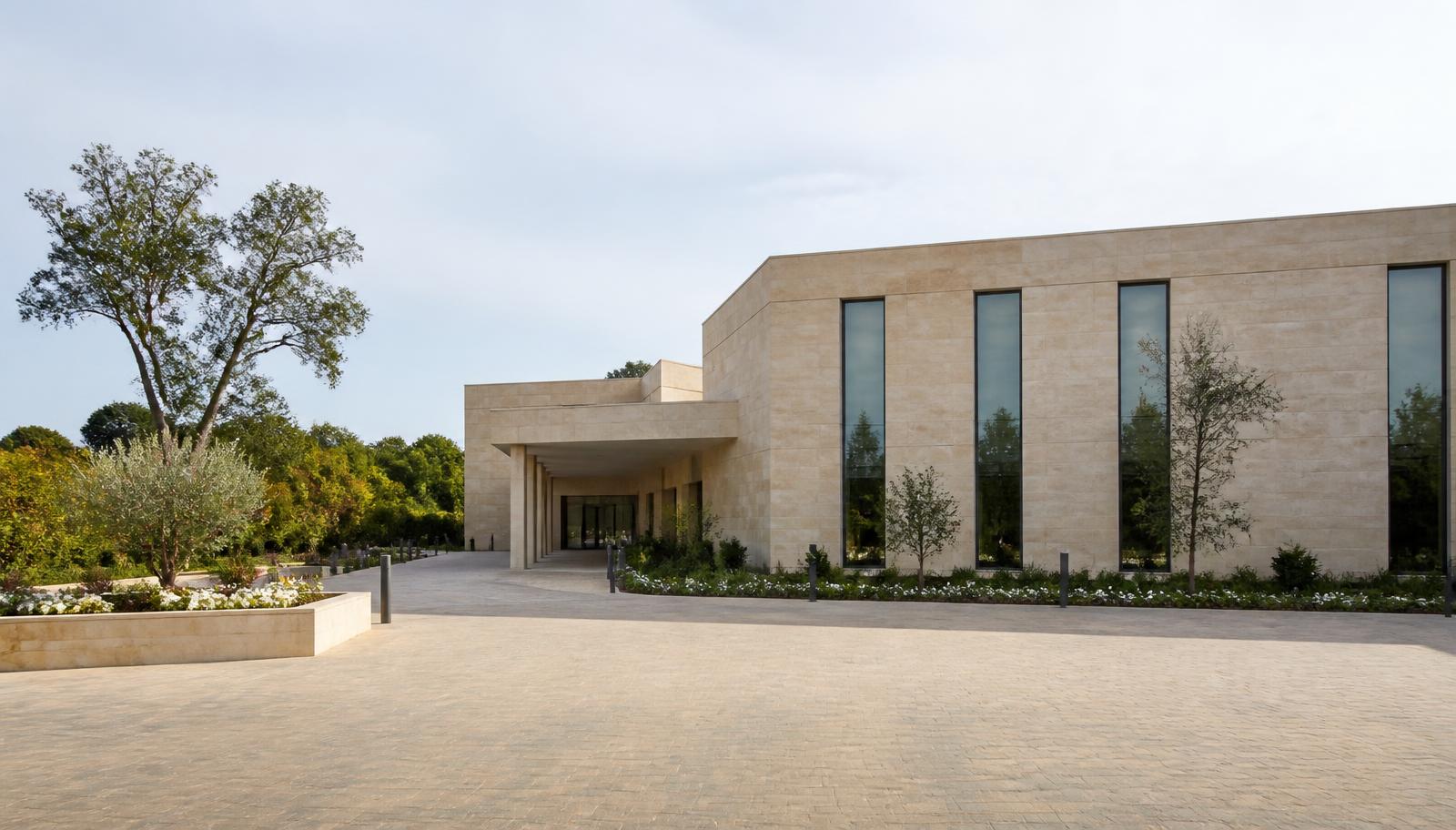 Clean stone-clad crematorium building with landscaped garden entrance