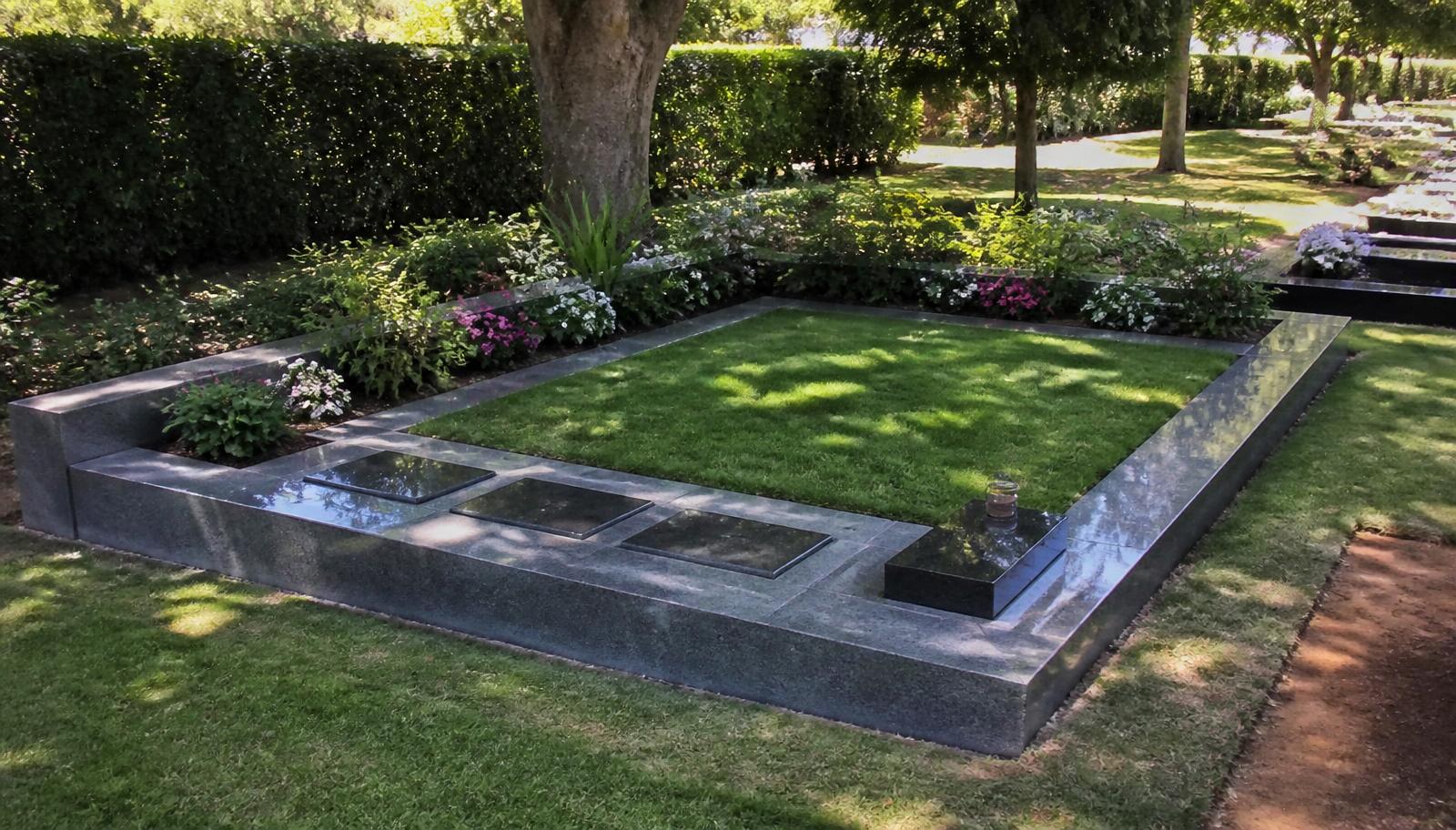 Granite family memorial plot with lawn centre, plaques and flower borders